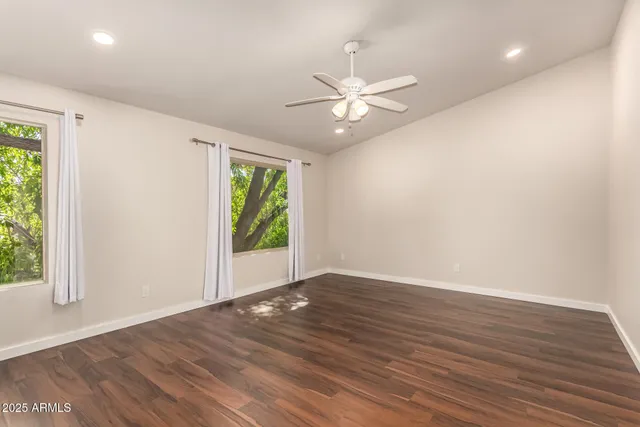 a bedroom with furniture and wooden floor