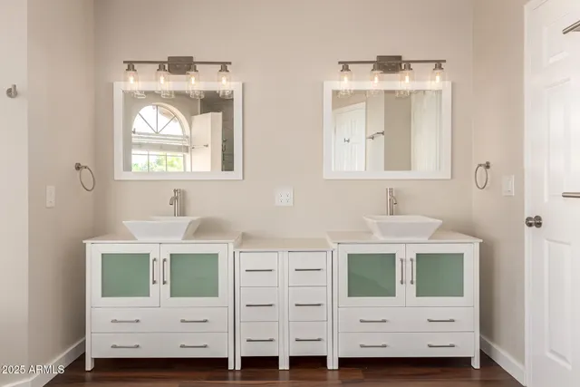 a view of a room with wooden floor and a ceiling fan