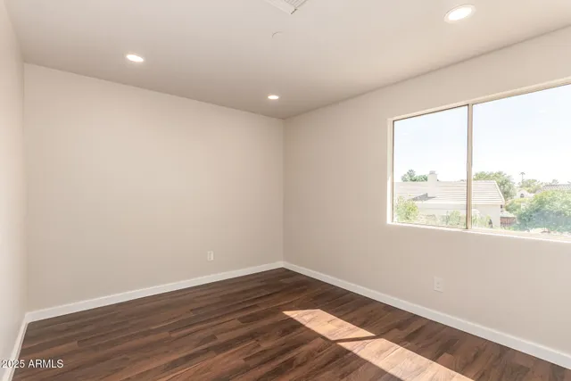 wooden floor in an empty room with a window