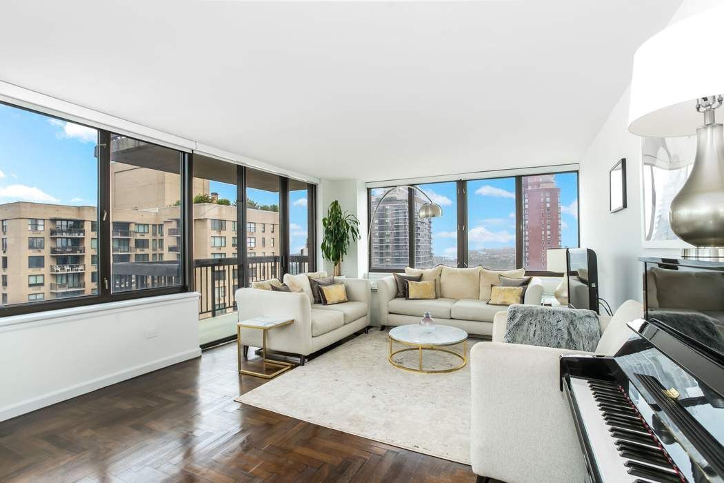 422 East 72nd Street, Unit 33A Manhattan, NY 10021 - Photo 3 of 18 a living room with furniture and a large window