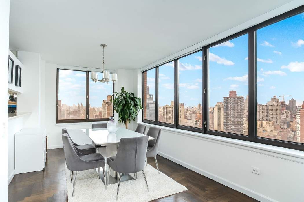 422 East 72nd Street, Unit 33A Manhattan, NY 10021 - Photo 4 of 18 a dining room with furniture window and wooden floor
