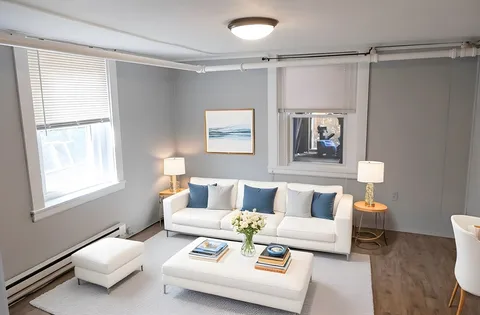 a living room with furniture and a window