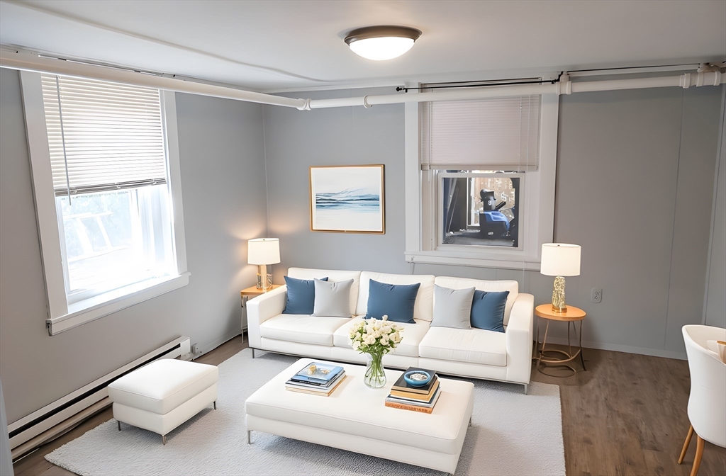 305 Rindge Avenue, Unit 1 Cambridge, MA 02140 - Photo 1 of 7 a living room with furniture and a window