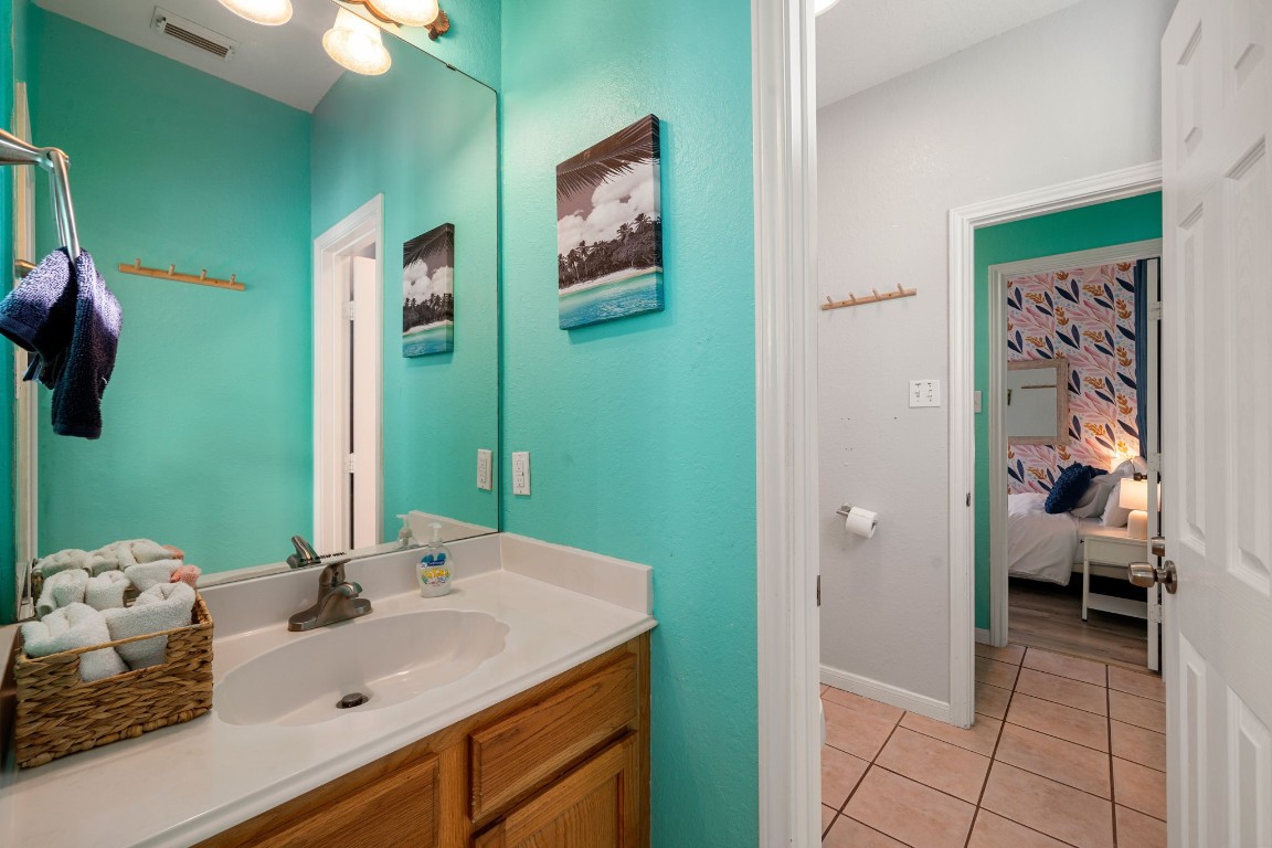 116 Starfish Street Surfside Beach, TX 77541 - Photo 22 of 49 a en suite bathroom with a sink and a mirror