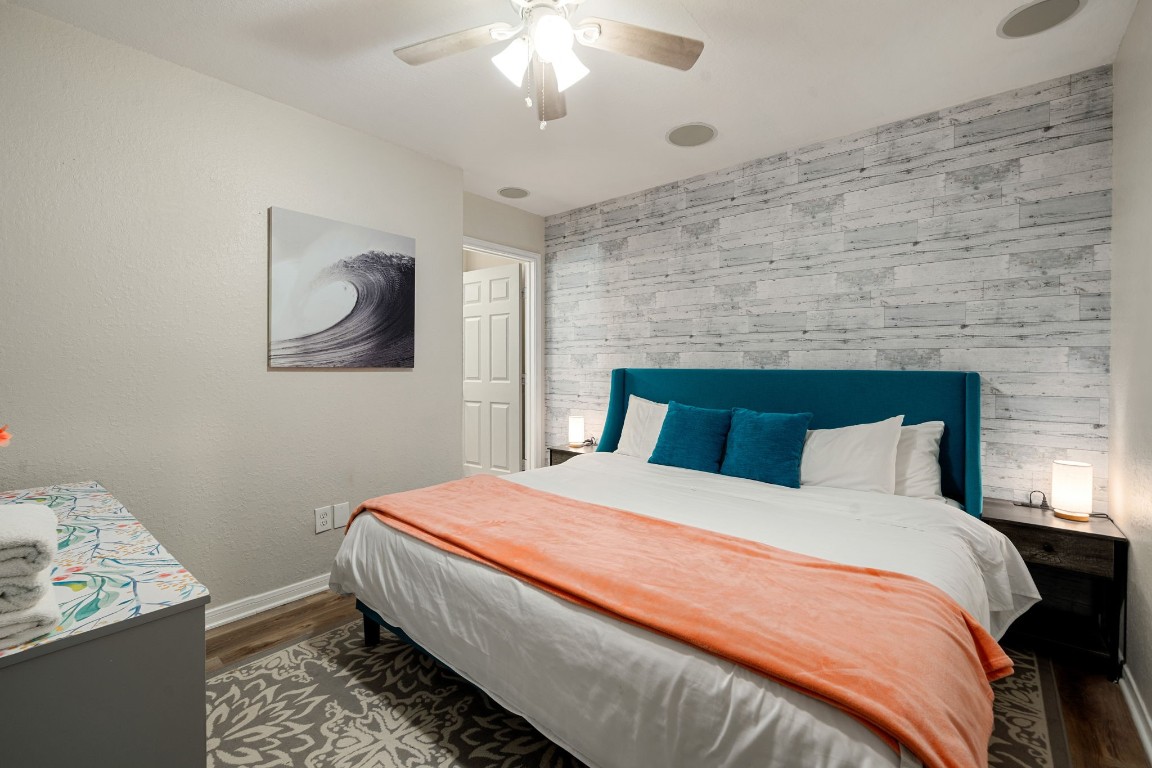 116 Starfish Street Surfside Beach, TX 77541 - Photo 30 of 49 a bedroom with a bed and a chandelier