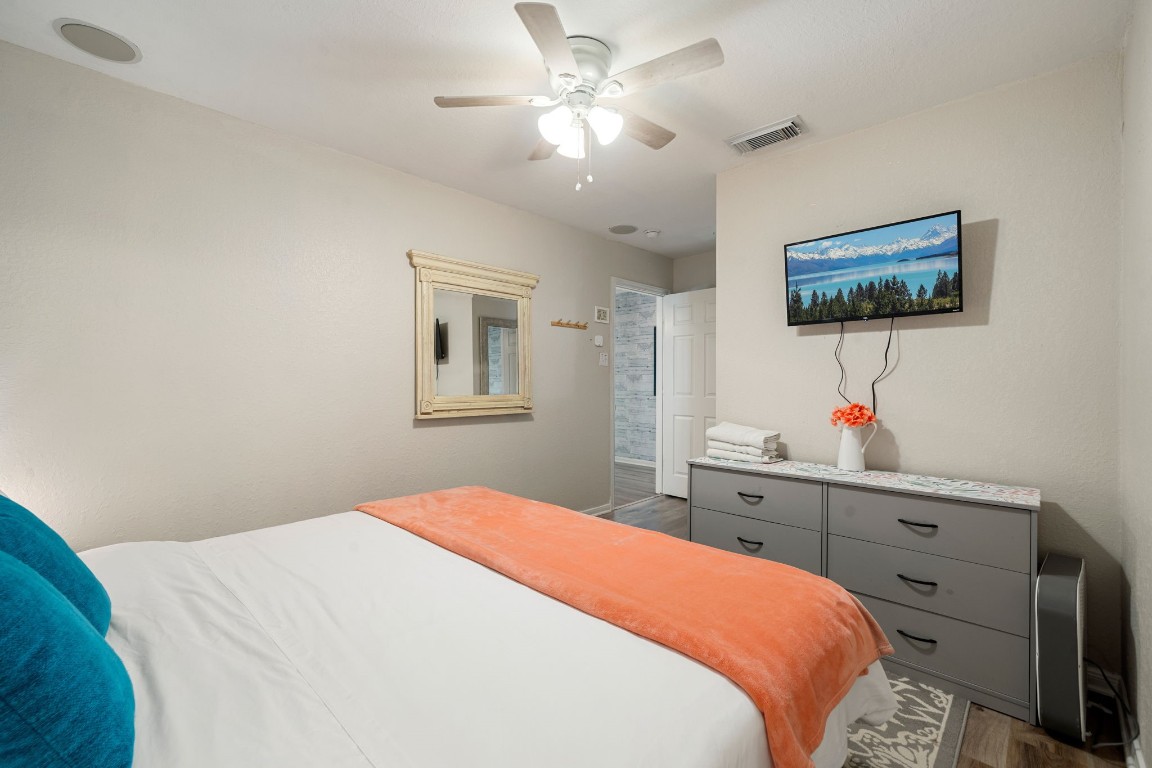 116 Starfish Street Surfside Beach, TX 77541 - Photo 31 of 49 a bedroom with a bed and a chandelier