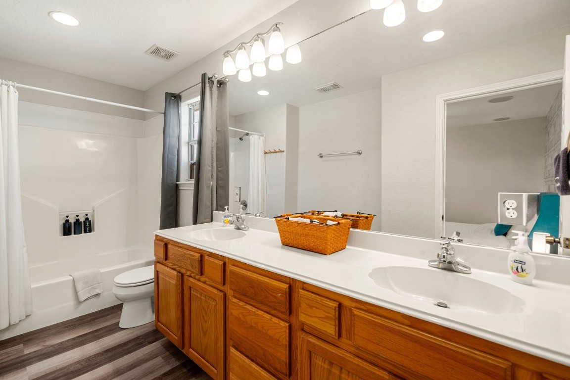 116 Starfish Street Surfside Beach, TX 77541 - Photo 32 of 49 a bathroom with a double vanity sink toilet mirror and shower