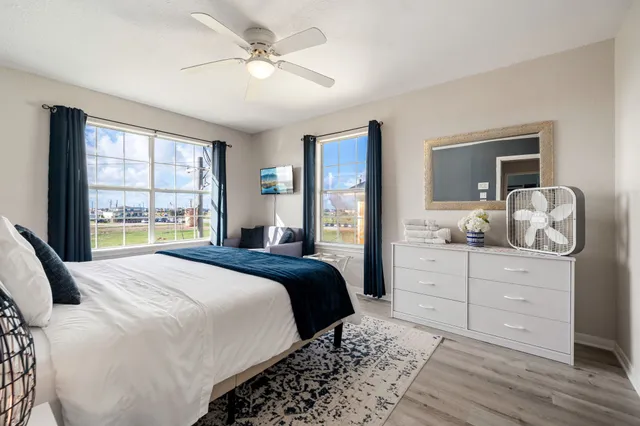 a bedroom with a large bed and a window