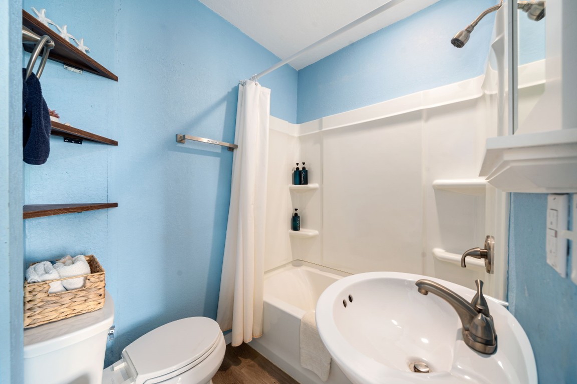116 Starfish Street Surfside Beach, TX 77541 - Photo 35 of 49 a bathroom with a sink a toilet and shower