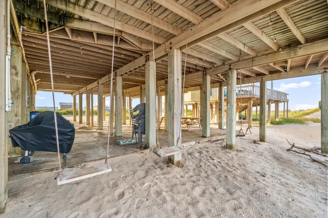 a view of a porch with a table and chairs