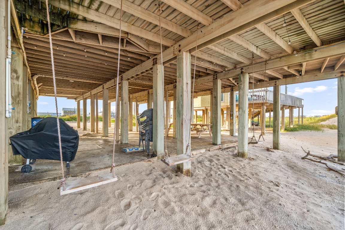 116 Starfish Street Surfside Beach, TX 77541 - Photo 41 of 49 a view of a porch with a table and chairs