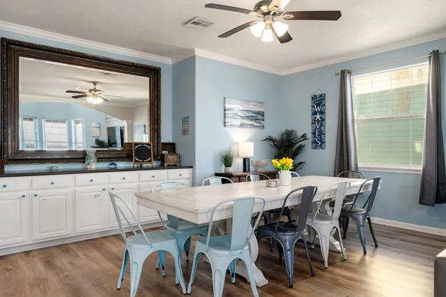 a view of a dining room with furniture window and wooden floor