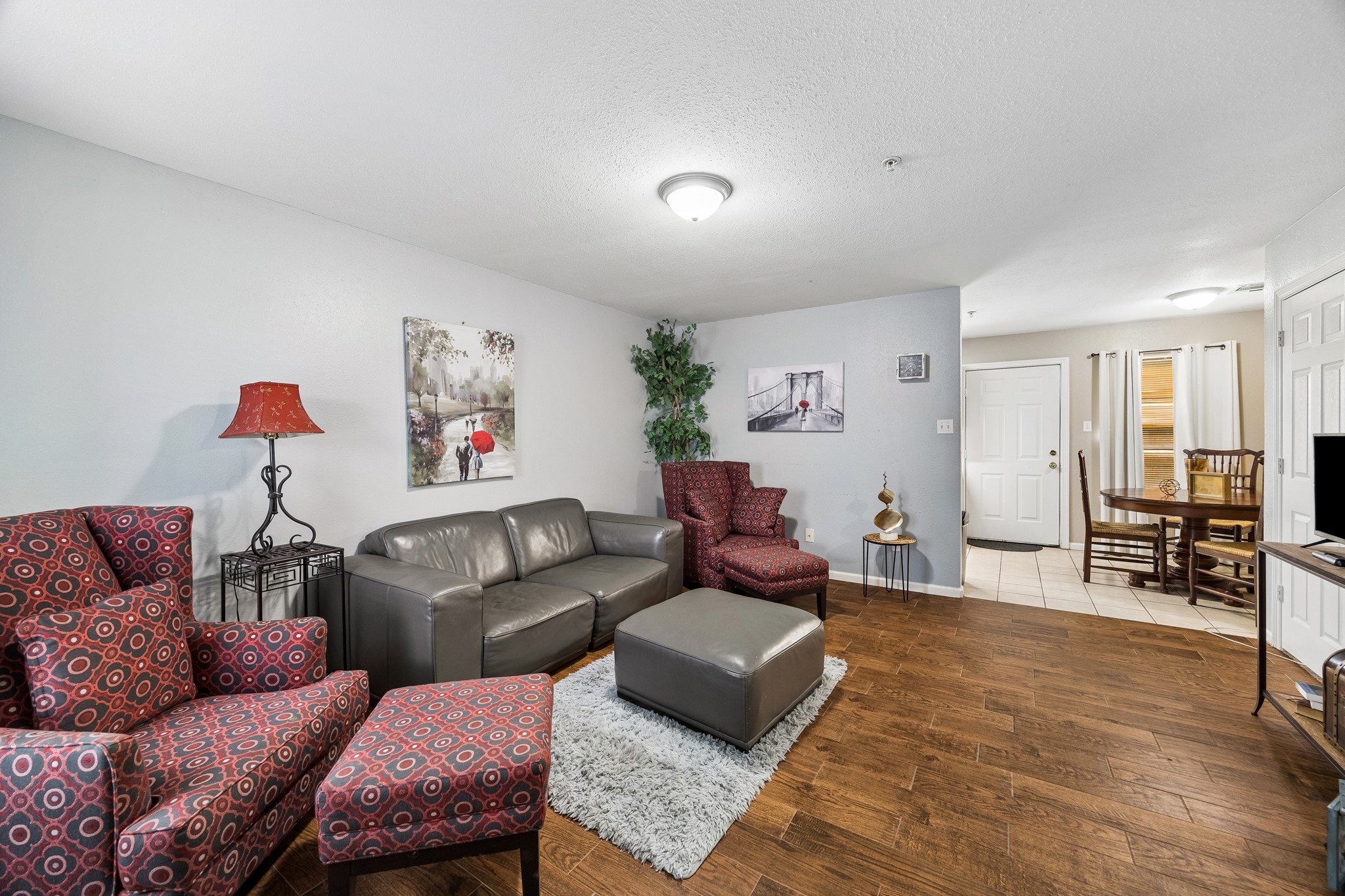 2013 Ellis School Road Baytown, TX 77521 - Photo 13 of 31 Bright and inviting living space designed for relaxing or entertaining, with space to gather and unwind. Hardwood flooring elevates the space, and contributes to the bright and airy elegance.