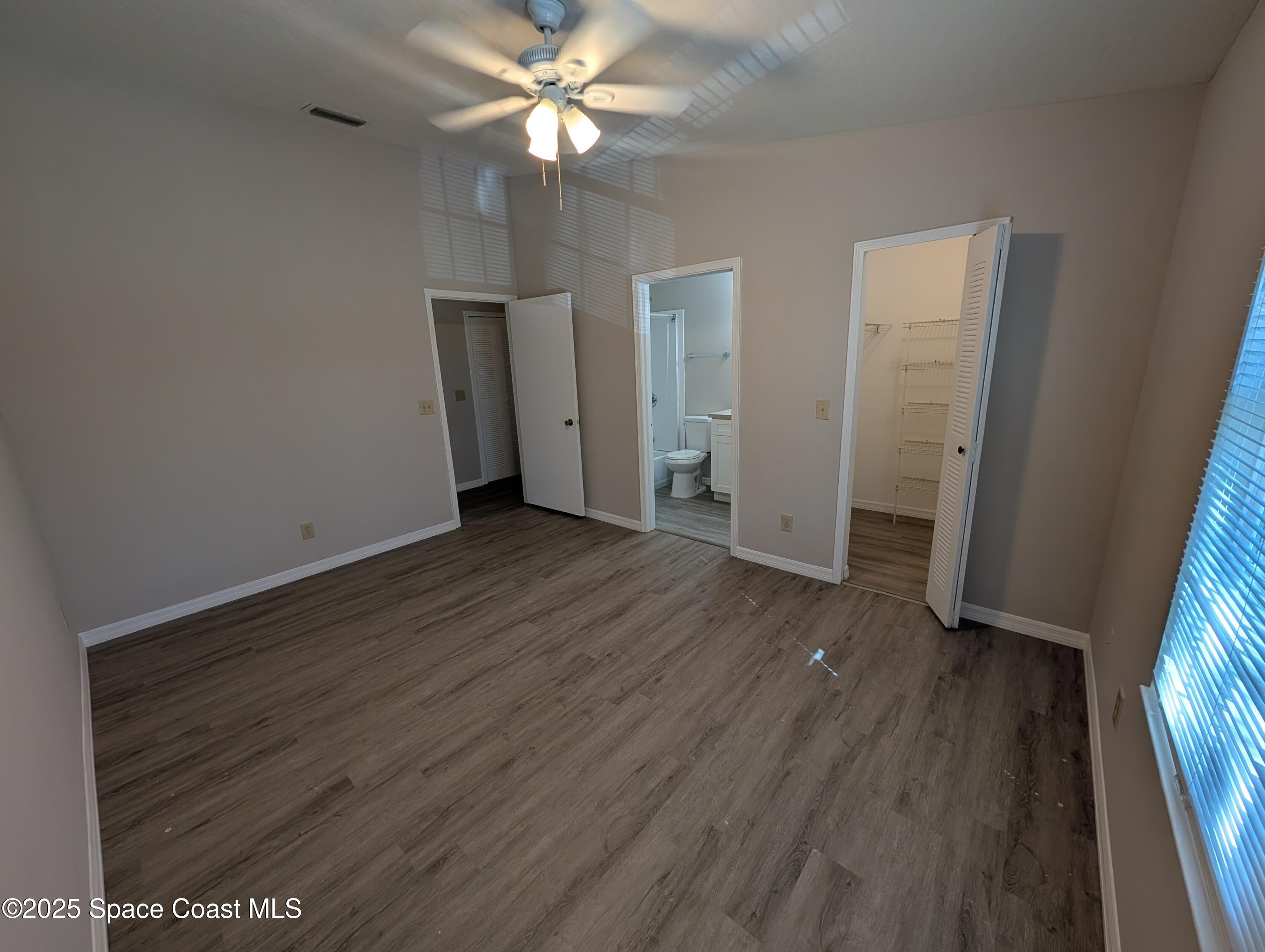 7667 North Wickham Road, Unit 1209 Melbourne, FL 32940 - Photo 11 of 23 wooden floor in an empty room with a window