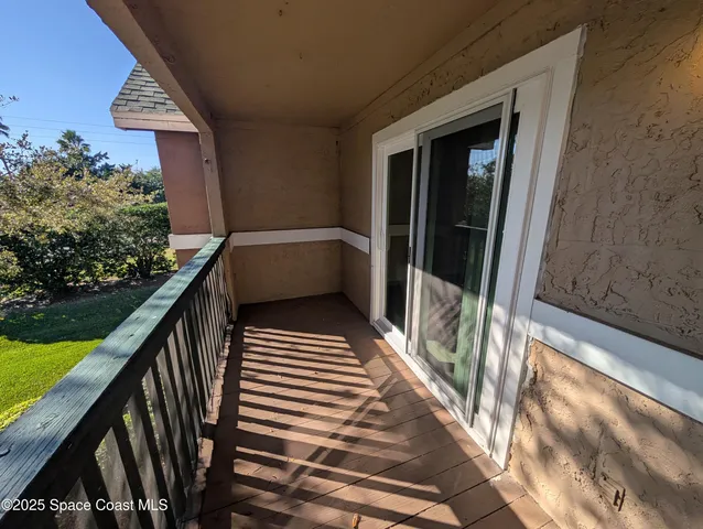 a view of balcony with wooden floor and stairs