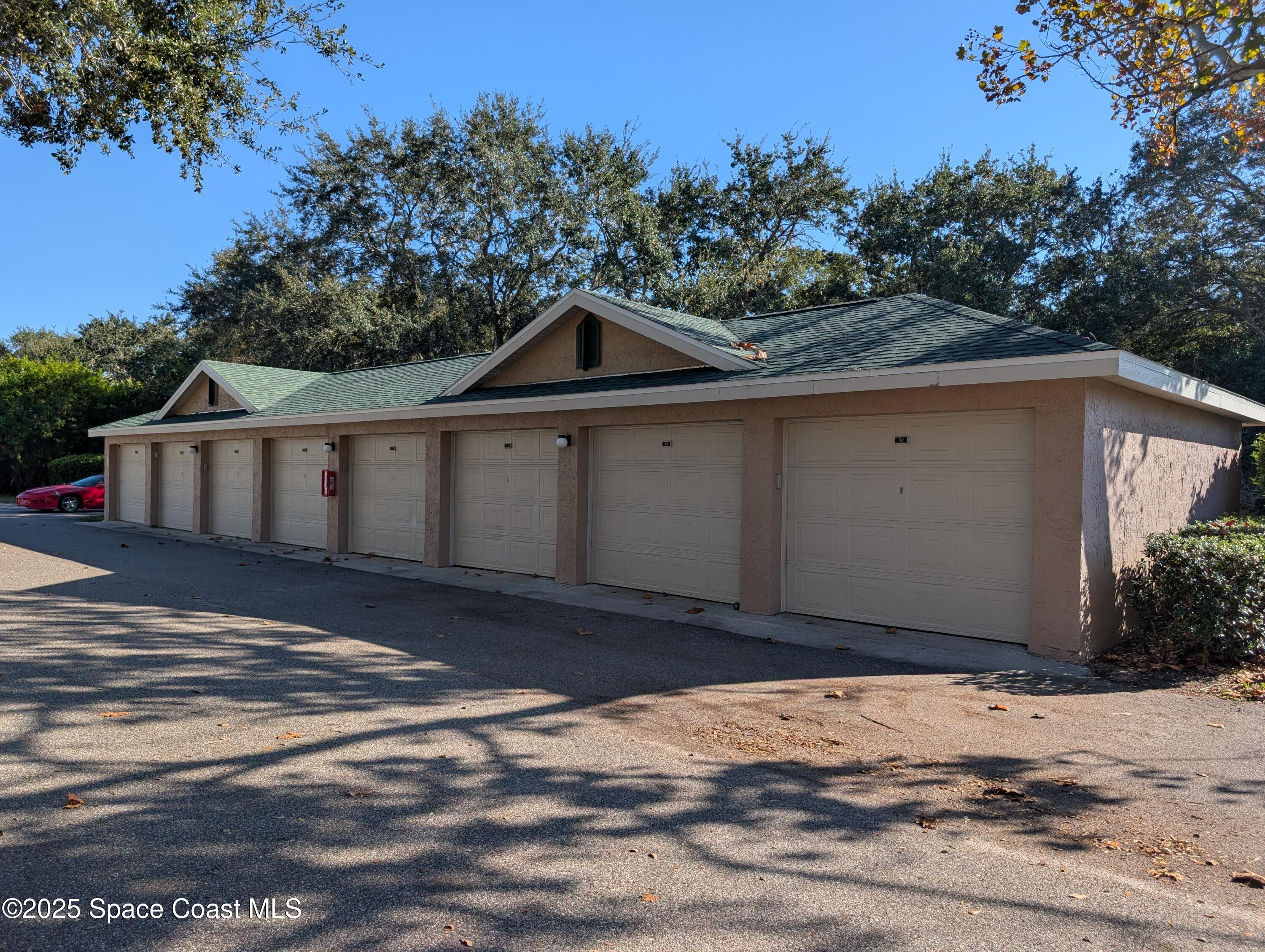 7667 North Wickham Road, Unit 1209 Melbourne, FL 32940 - Photo 18 of 23 a view of a wooden house with a yard