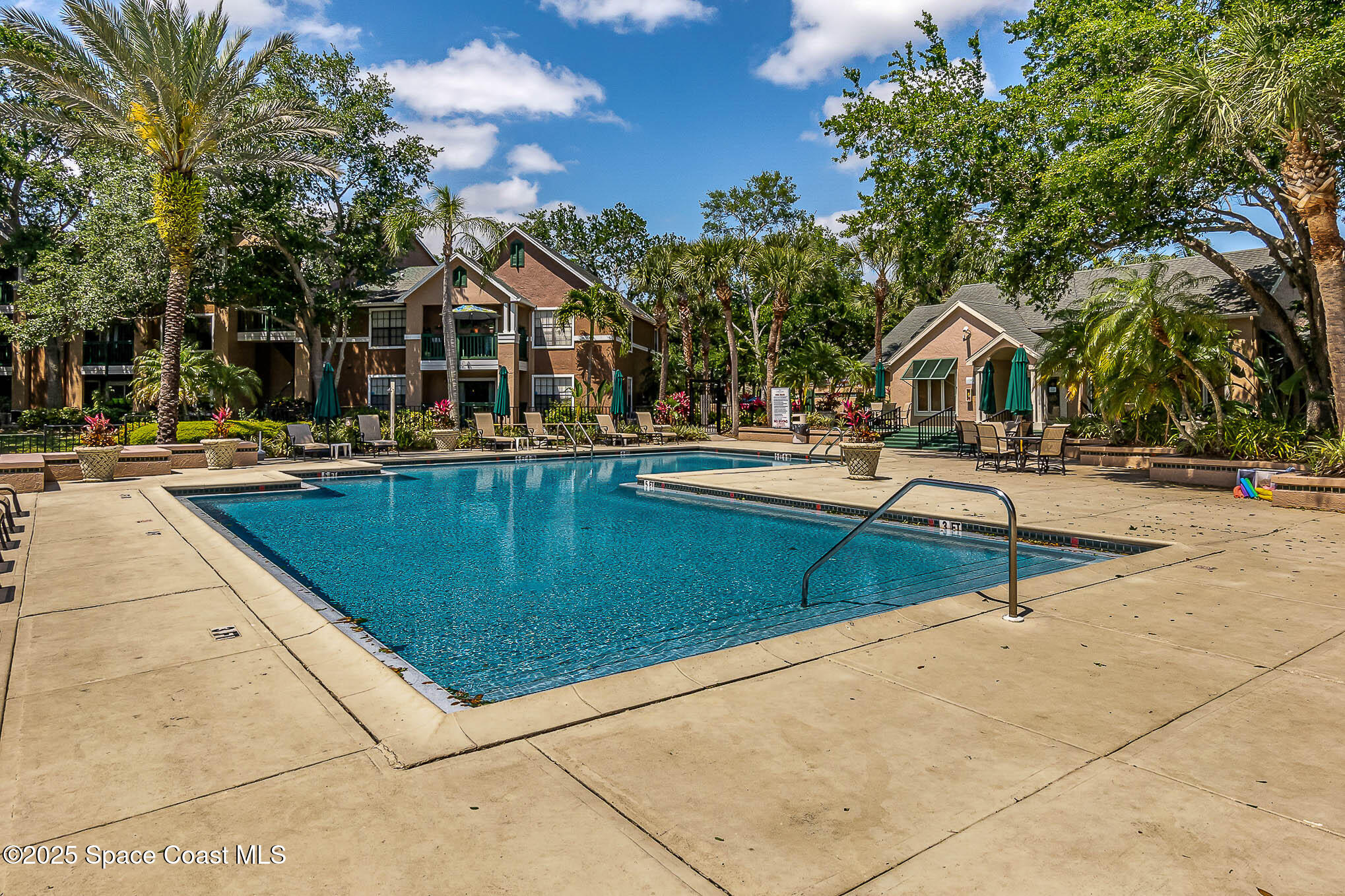 7667 North Wickham Road, Unit 1209 Melbourne, FL 32940 - Photo 20 of 23 a view of a swimming pool with a lounge chairs