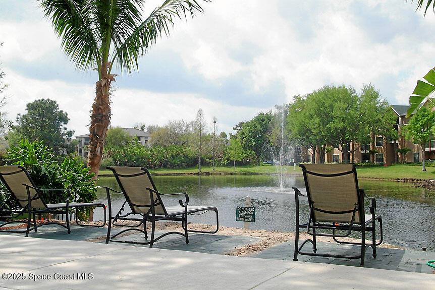 7667 North Wickham Road, Unit 1209 Melbourne, FL 32940 - Photo 21 of 23 a view of a lake with outdoor seating space