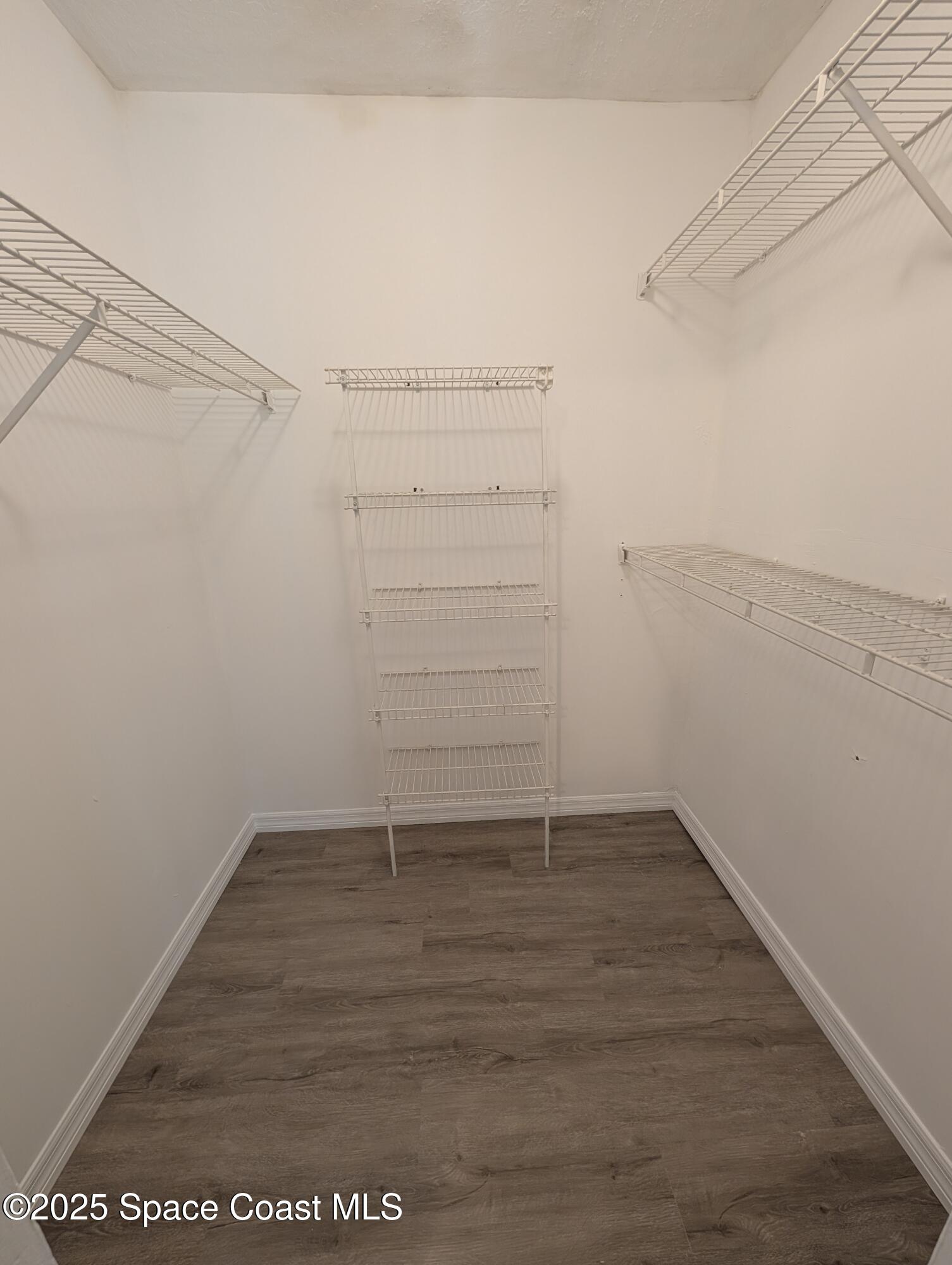 7667 North Wickham Road, Unit 1209 Melbourne, FL 32940 - Photo 9 of 23 a view of an empty walk in closet
