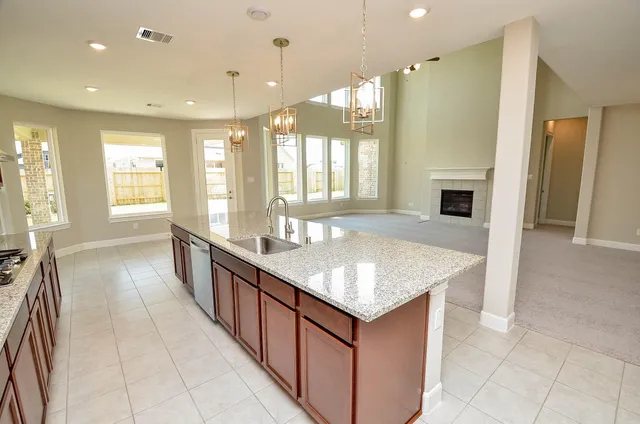 a large kitchen with kitchen island granite countertop a large window