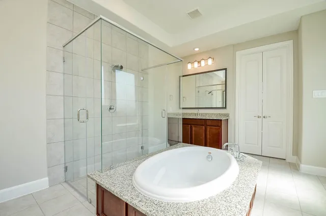 a bathroom with a granite countertop sink a toilet and shower