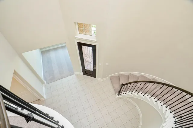 a view of a bedroom with wooden floor and staircase