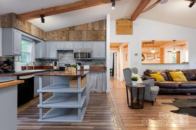 a kitchen with stainless steel appliances granite countertop a stove and white cabinets