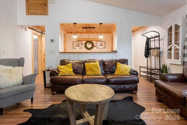 a living room with furniture a rug and a table