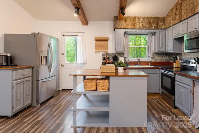 a kitchen with a sink appliances and cabinets