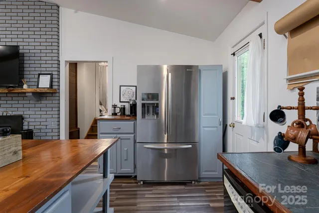 a kitchen with stainless steel appliances granite countertop a refrigerator and a stove top oven
