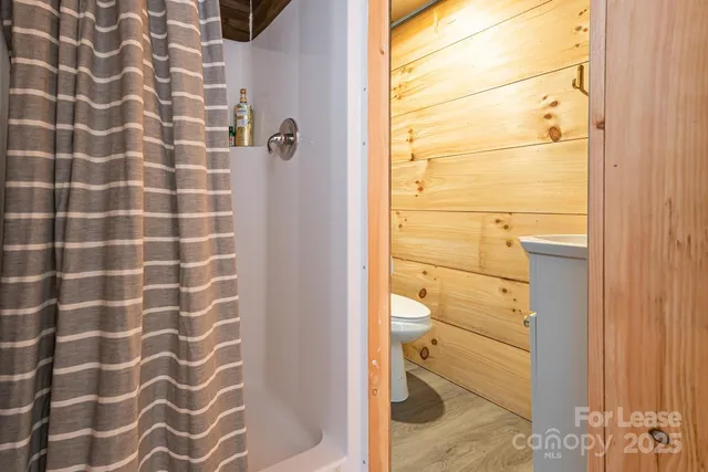 a bathroom with a shower and a sink