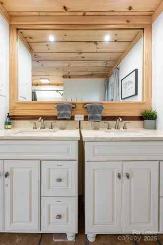 a utility room with stainless steel appliances granite countertop a sink and a window