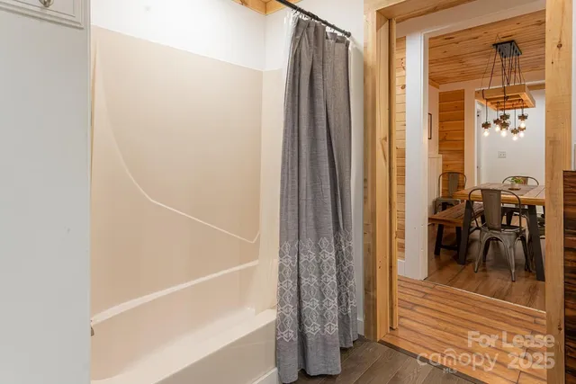 a view of a balcony with chairs and front door