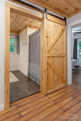 a view of entryway and hall with wooden floor