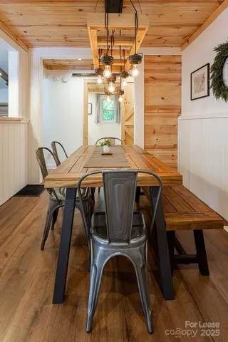 a view of a dining room with furniture and chandelier