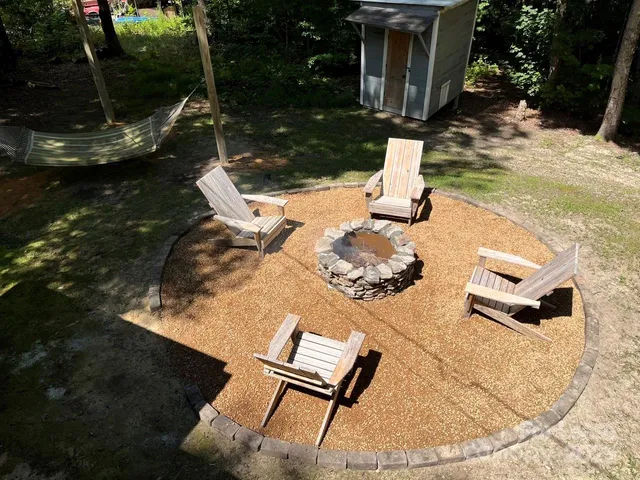 a backyard of a house with table and chairs