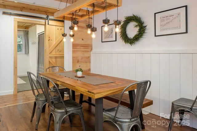 a view of a dining room with furniture and wooden floor