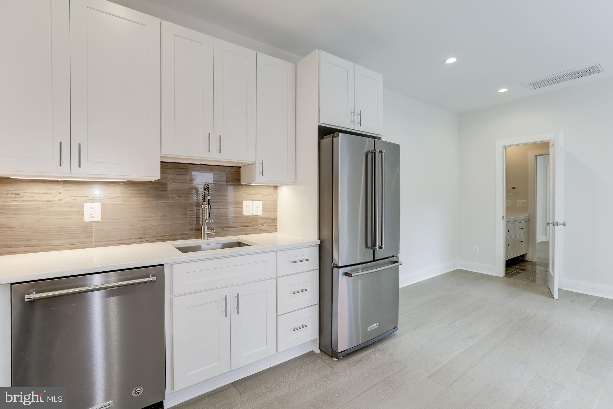 4008 Edmunds Street Northwest, Unit 9 Washington, DC 20007 - Photo 16 of 30 a kitchen with cabinets and stainless steel appliances