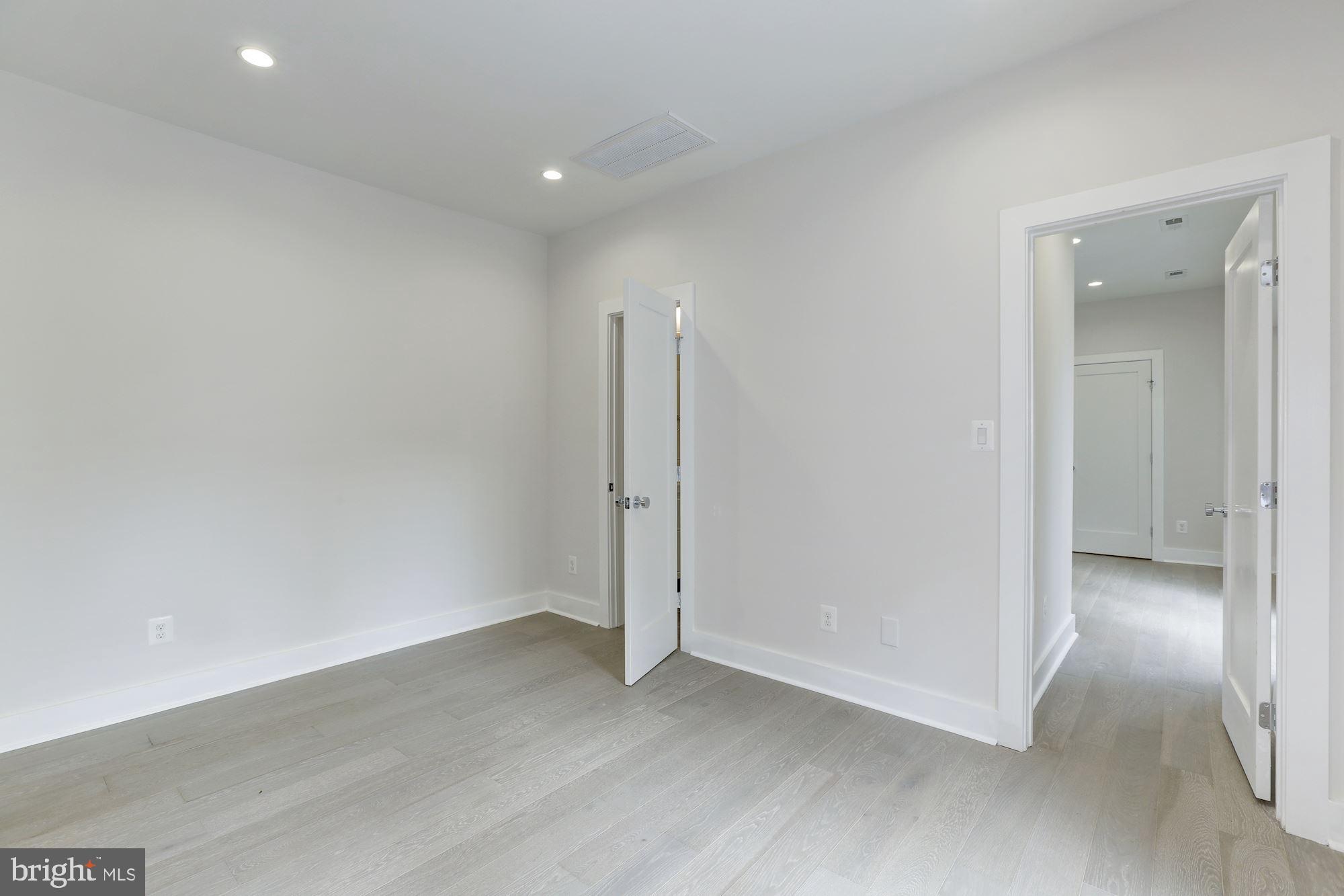 4008 Edmunds Street Northwest, Unit 9 Washington, DC 20007 - Photo 17 of 30 an empty room with wooden floor and sliding door
