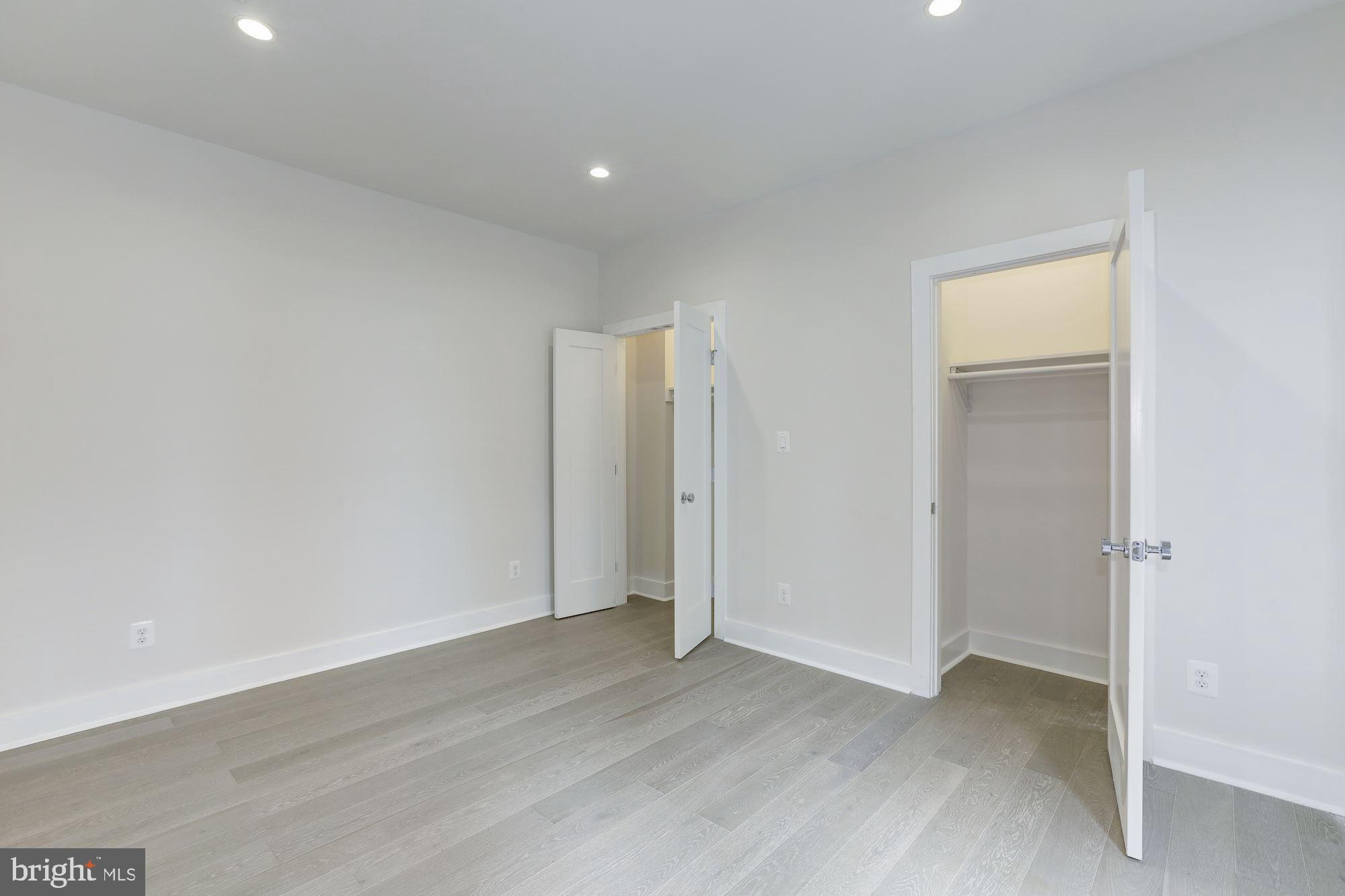 4008 Edmunds Street Northwest, Unit 9 Washington, DC 20007 - Photo 19 of 30 an empty room with wooden floor and closet