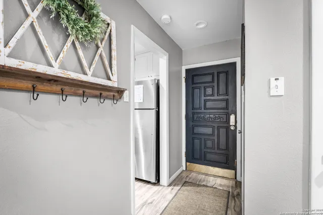 a bedroom with a bed and a painting on the wall