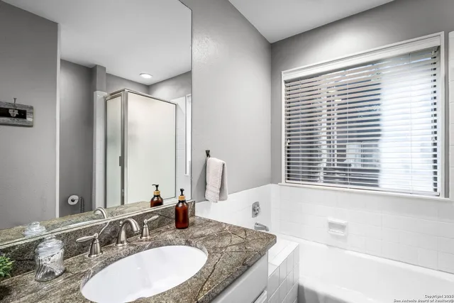 a bathroom with a granite countertop sink a toilet and a mirror