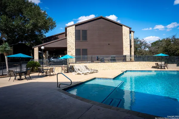 a view of a house with swimming pool and sitting area