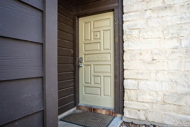a street sign on a wall next to a building