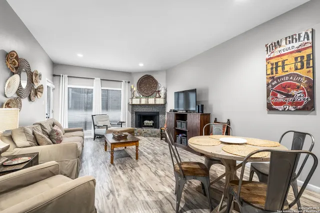 a living room with furniture and a fireplace