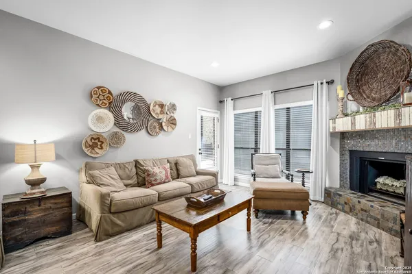 a living room with furniture and a fireplace
