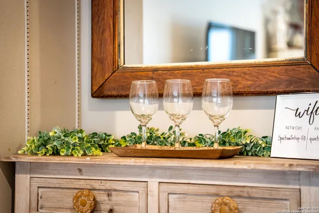 a kitchen with stainless steel appliances kitchen island granite countertop a refrigerator and a dining table