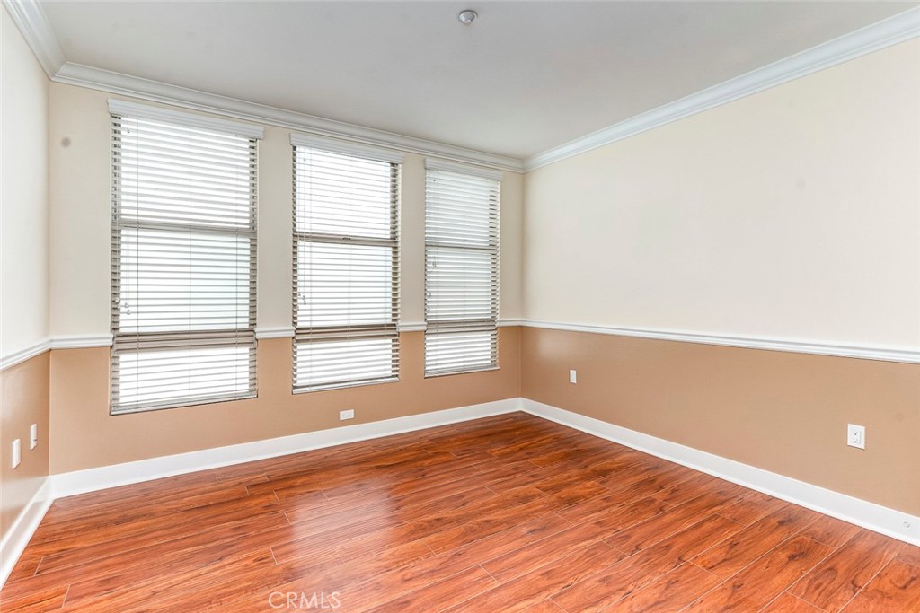 596 South Brea Boulevard Brea, CA 92821 - Photo 13 of 33 a view of empty room with wooden floor and fan