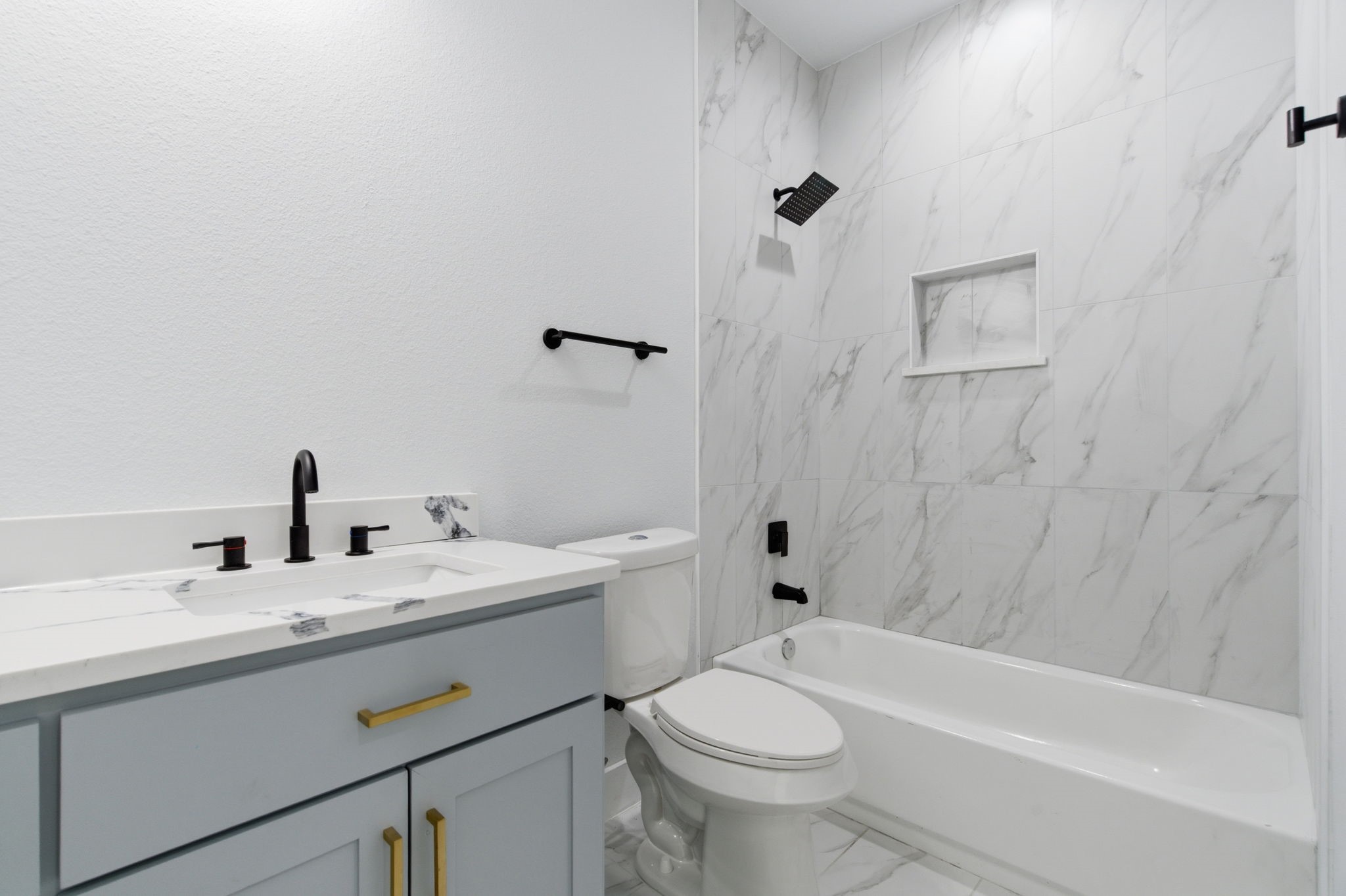 7040 Kinney Street Houston, TX 77087 - Photo 25 of 47 a bathroom with a sink a toilet and shower