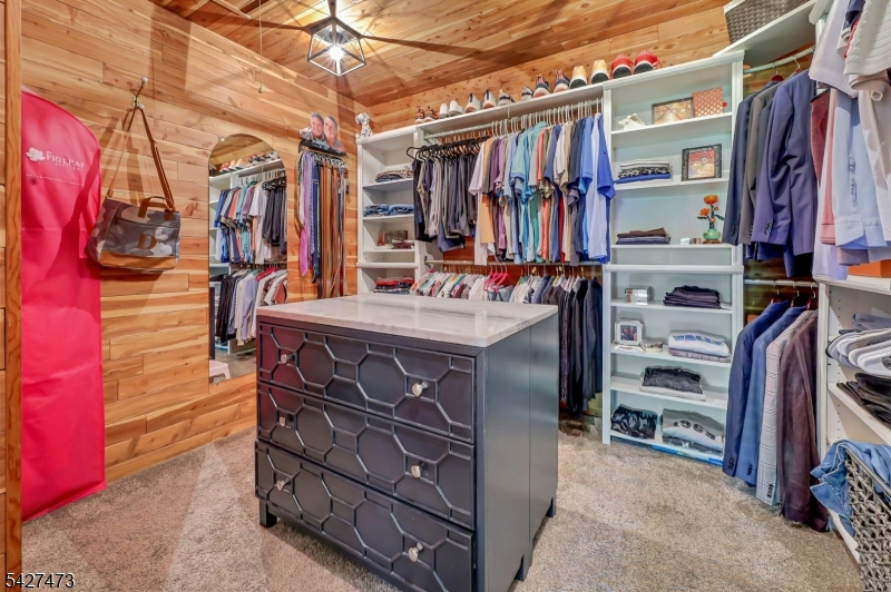 100 Easedale Road, Unit 100 Wayne, NJ 07470 - Photo 38 of 43 a view of walk in closet with clothes and shoes